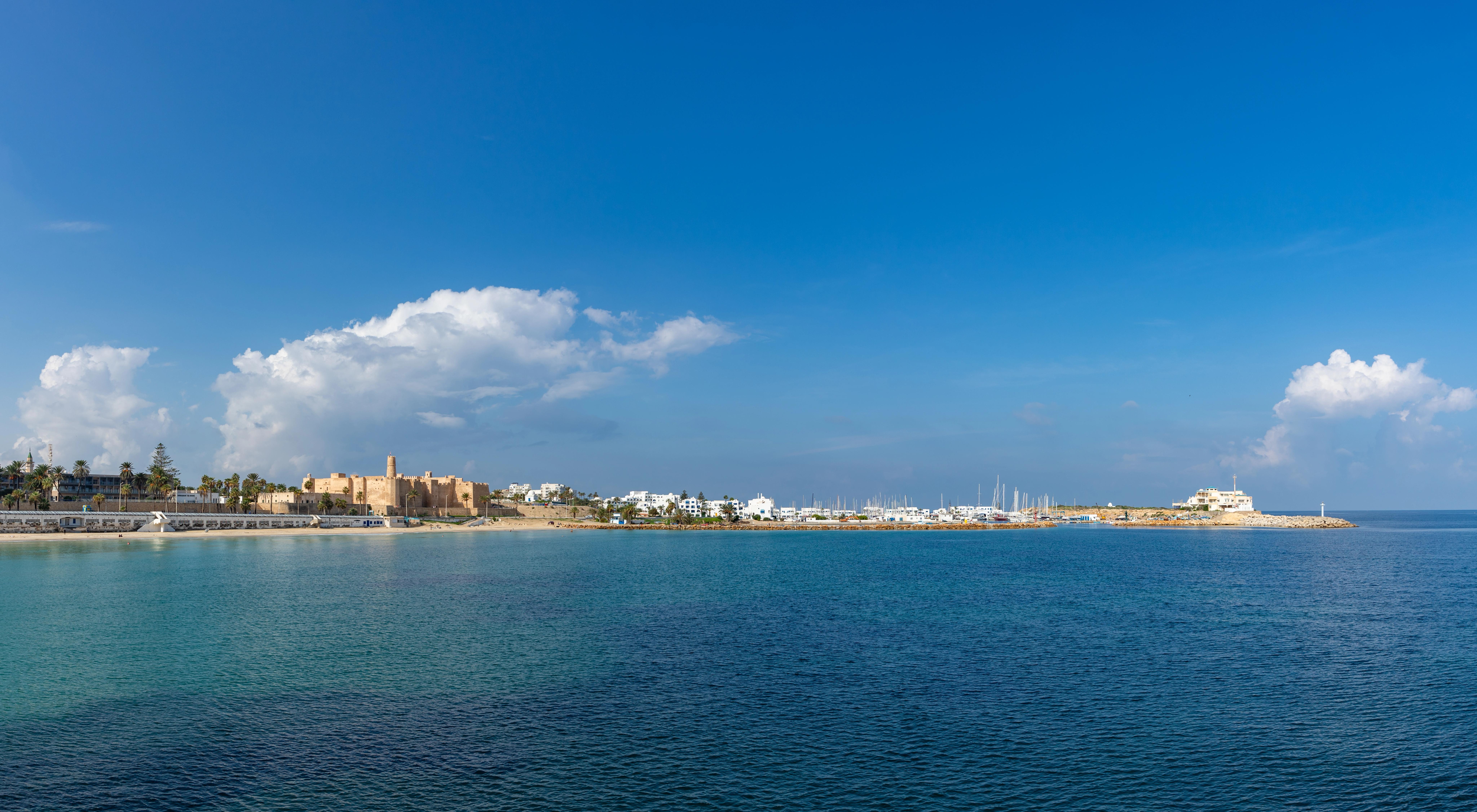 Klidná mořská hladina s výhledem na přístav a město